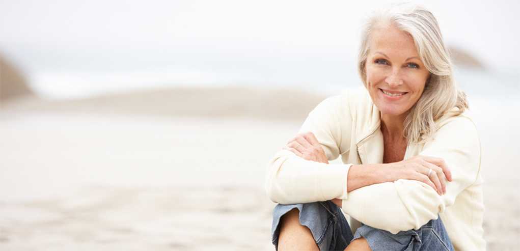 Lady Sitting on the Beach Content with the Mole Removal Treatment Received.